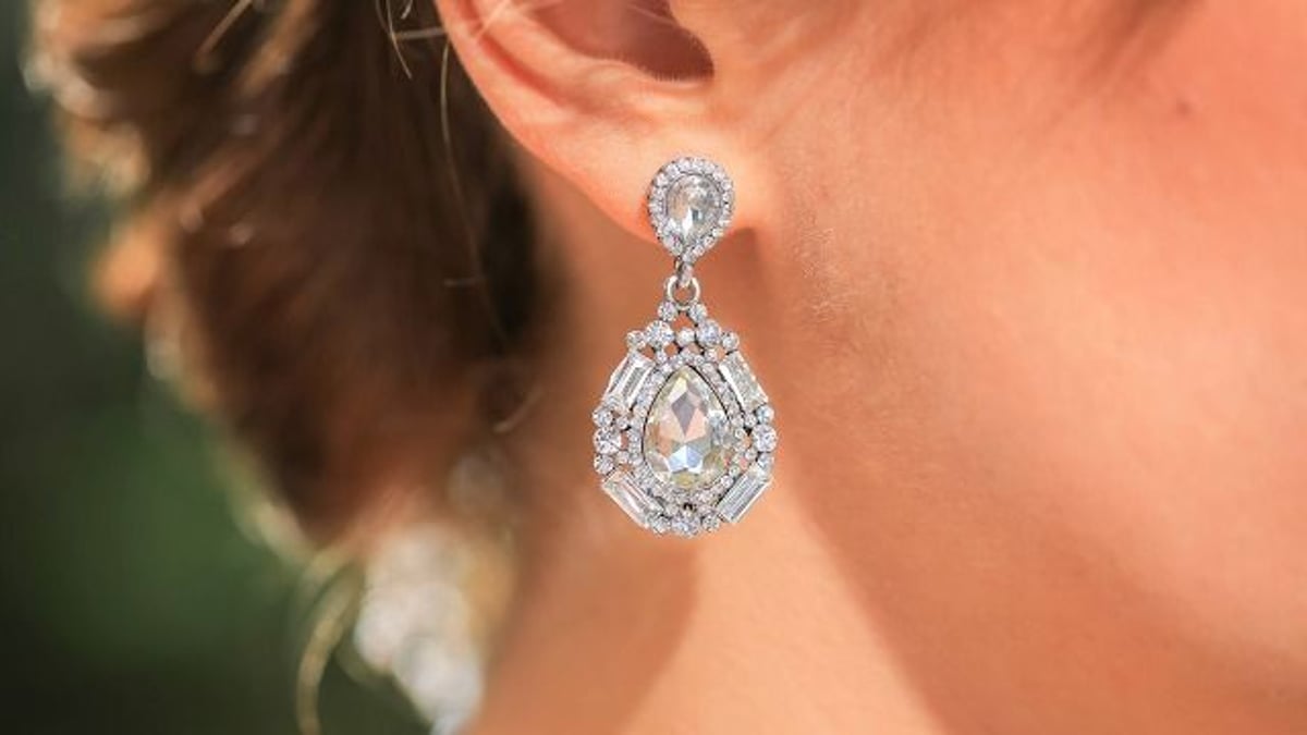 Bride asks if she should press charges against MIL after police find earrings in purse.