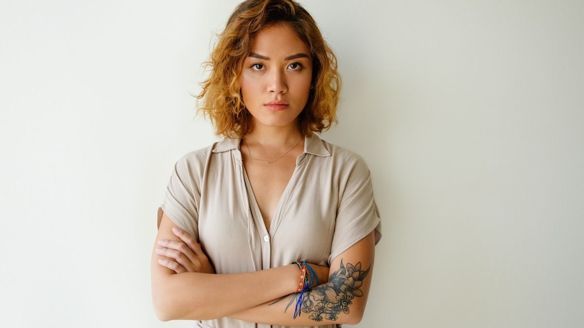 'AITA for leaving my friend’s wedding early after she made me cover my tattoos?'