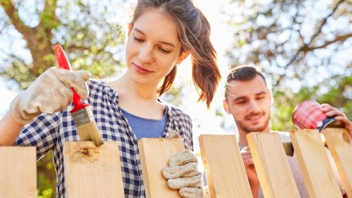 Man watches neighbors paint fence before telling them it's on 'his side' of property.