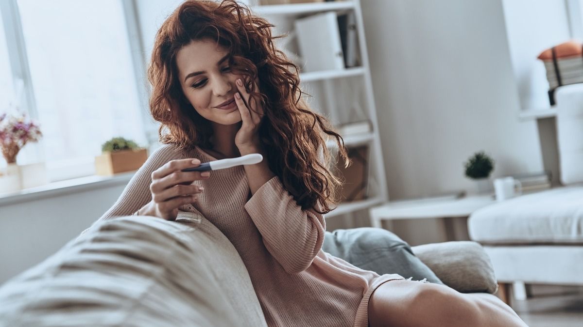 Woman doesn't want to ruin stay-at-home husband's trip by revealing pregnancy. AITA? UPDATED.